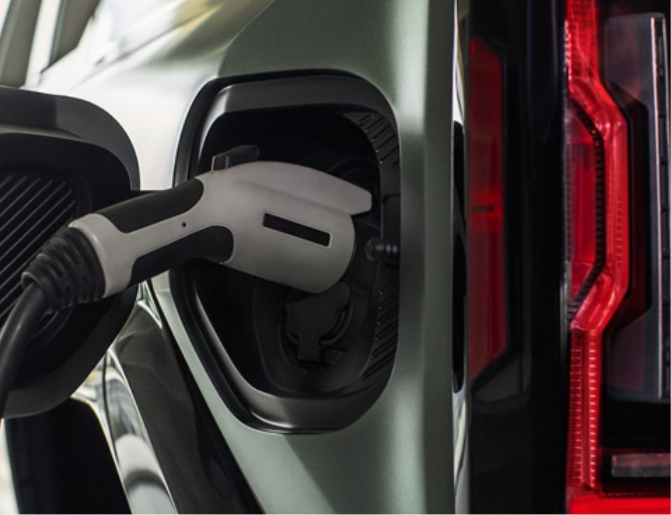 Close up of charging port with charger plugged in on a GMC Hummer EV SUV - Yellowstone Motors GMC in POWELL WY